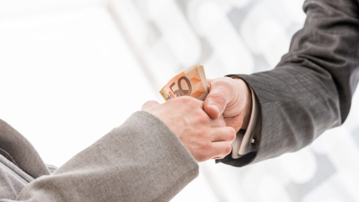 Businessman with Money Handshaking with Partner