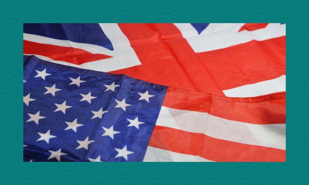 Close-up of overlapping United States and United Kingdom flags, showing the blue field with white stars from the U.S. flag and the red, white, and blue Union Jack above it, both slightly wrinkled as they lie together.